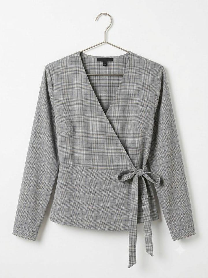 Grey plaid wrap top with tie waist, long sleeves, on a hanger